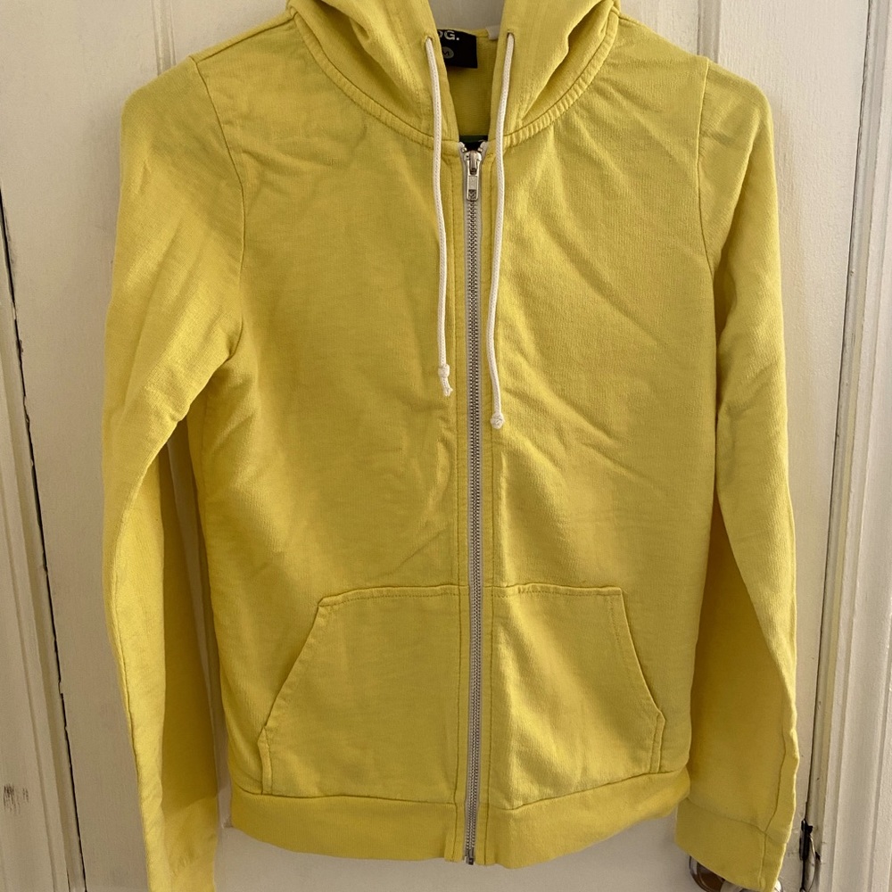 Woman’s pale yellow zip up hoodie